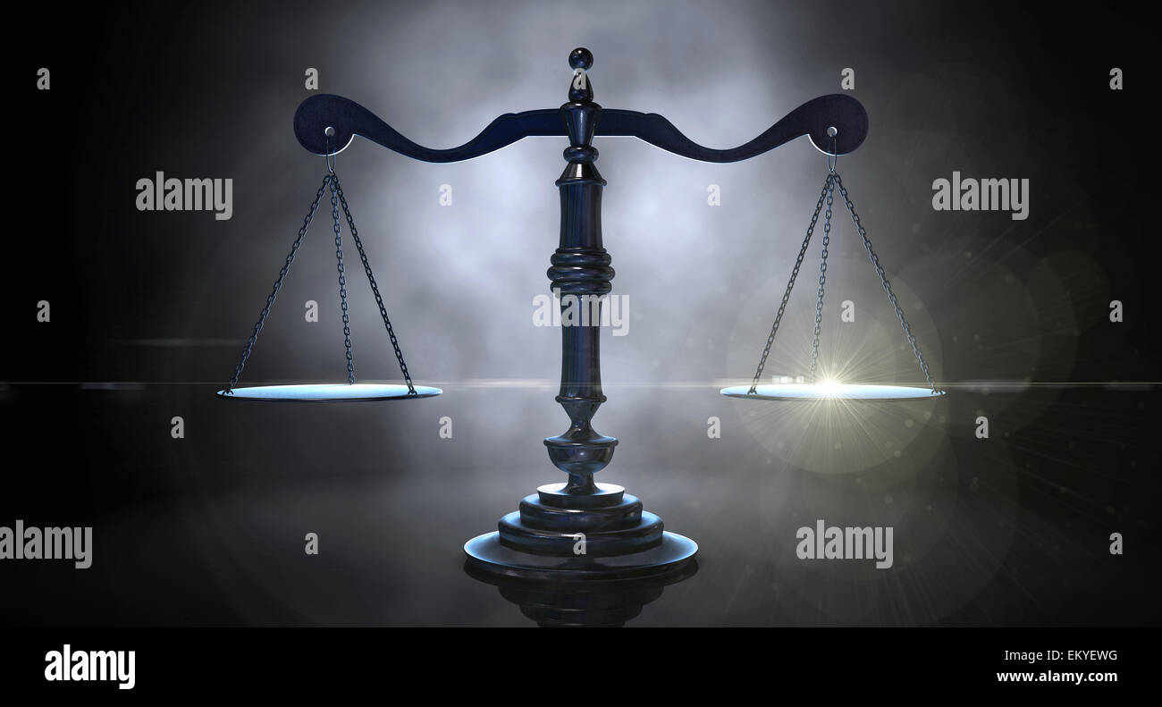 An gold justice scale backlight an an eerie dark background Stock Photo