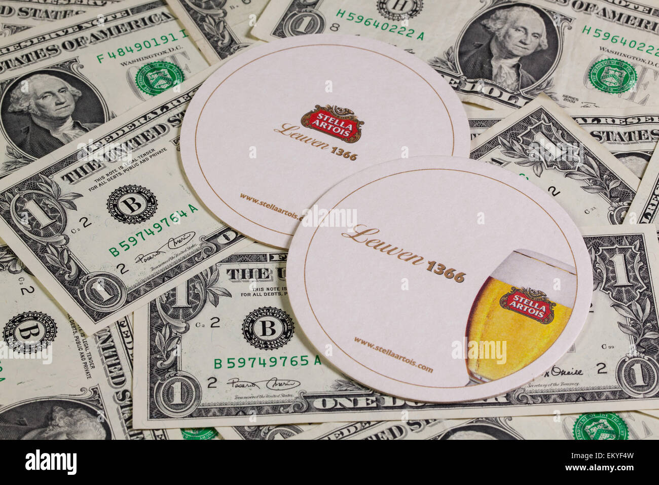 England,London - November 11, 2014:Beermats from Stella Artois and US dollars.It has been brewed in Leuven, Belgium, since 1926. Stock Photo