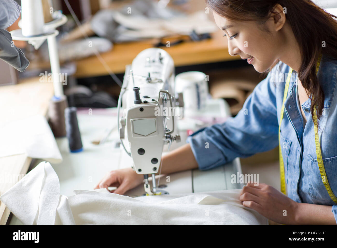 Fashion designer using sewing machine Stock Photo Alamy