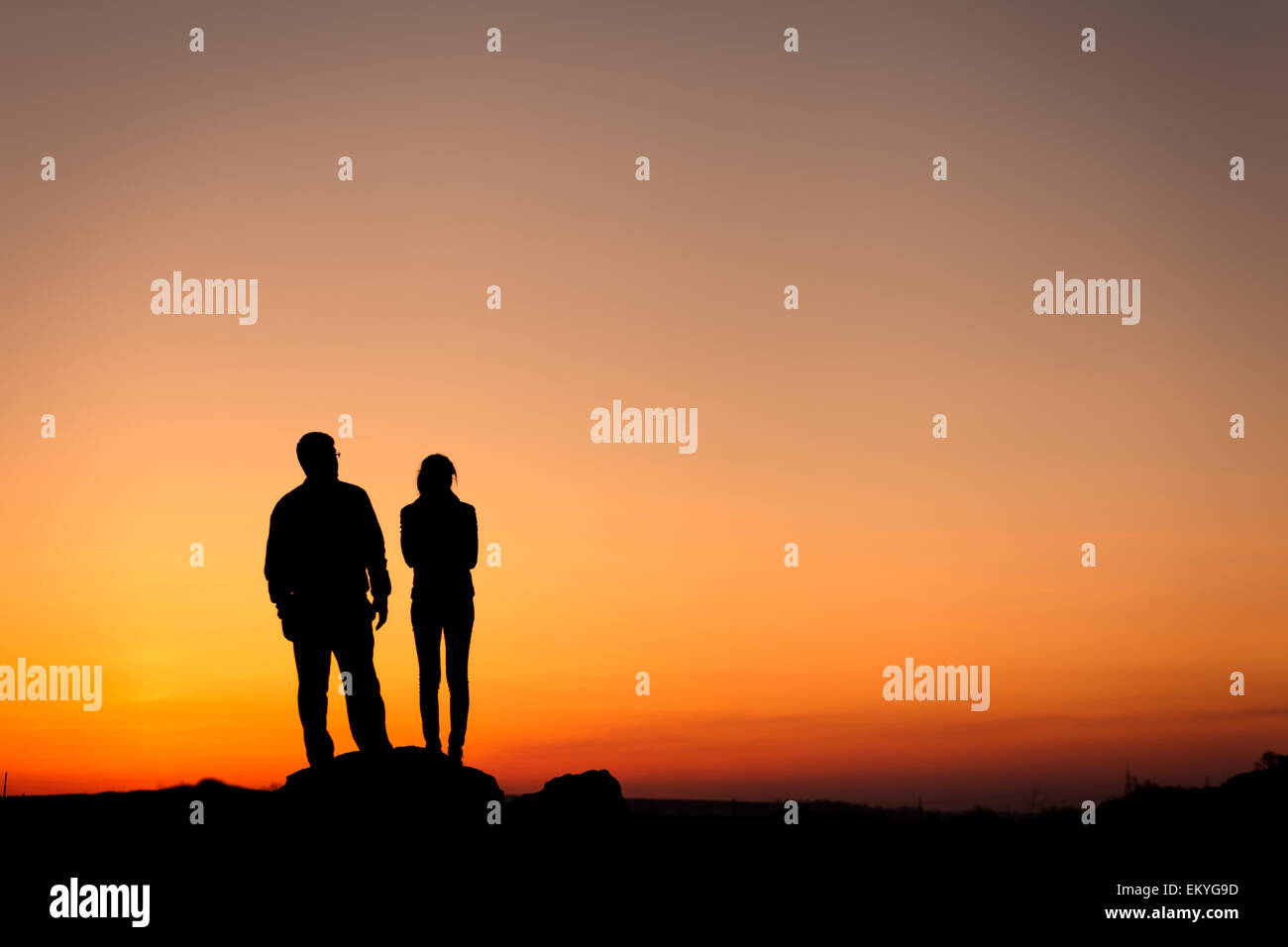 Silhouette of happiness family against beautiful colorful sky. Summer Sunset. Landscape Stock Photo