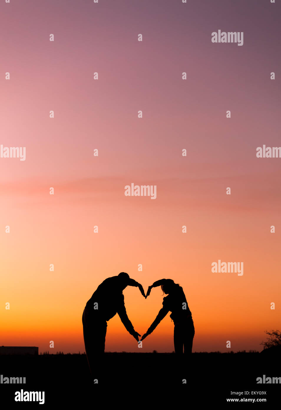 Conceptual heart shape, symbol of human. Woman and man hand silhouette ...