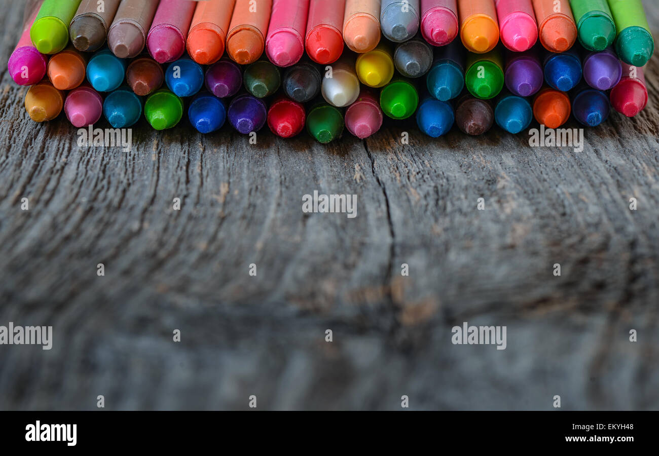 Coloring pencils aligned on wooden background Stock Photo