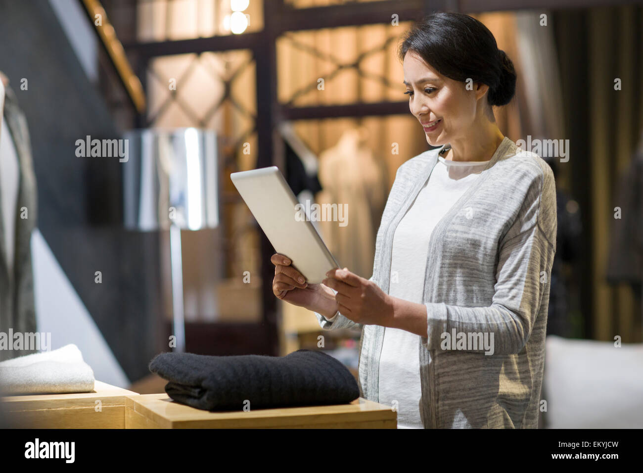 Clothing store owner with digital tablet Stock Photo Alamy
