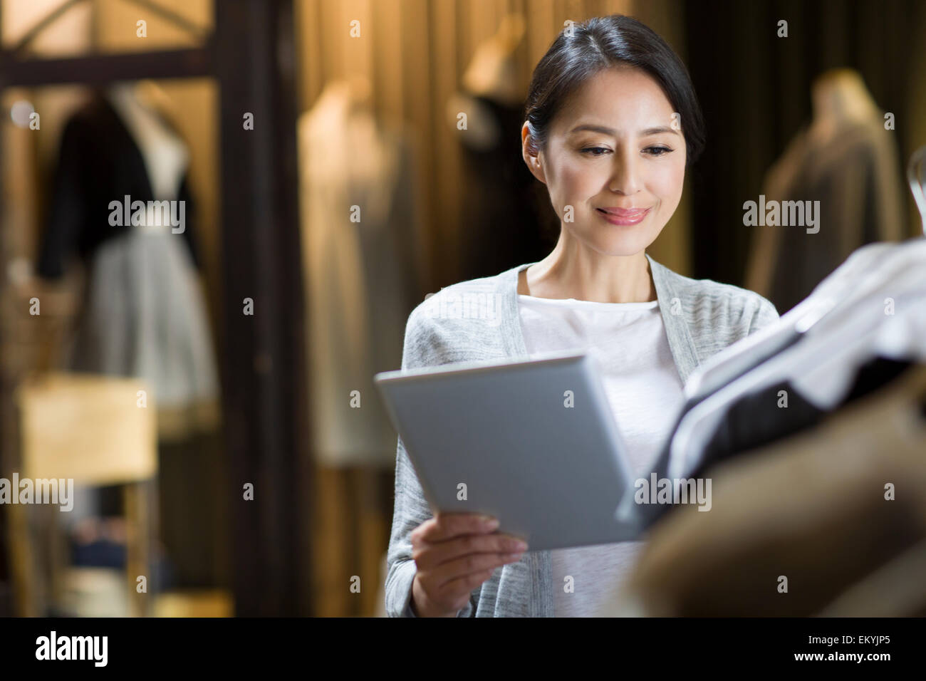 Clothing store owner with digital tablet Stock Photo Alamy