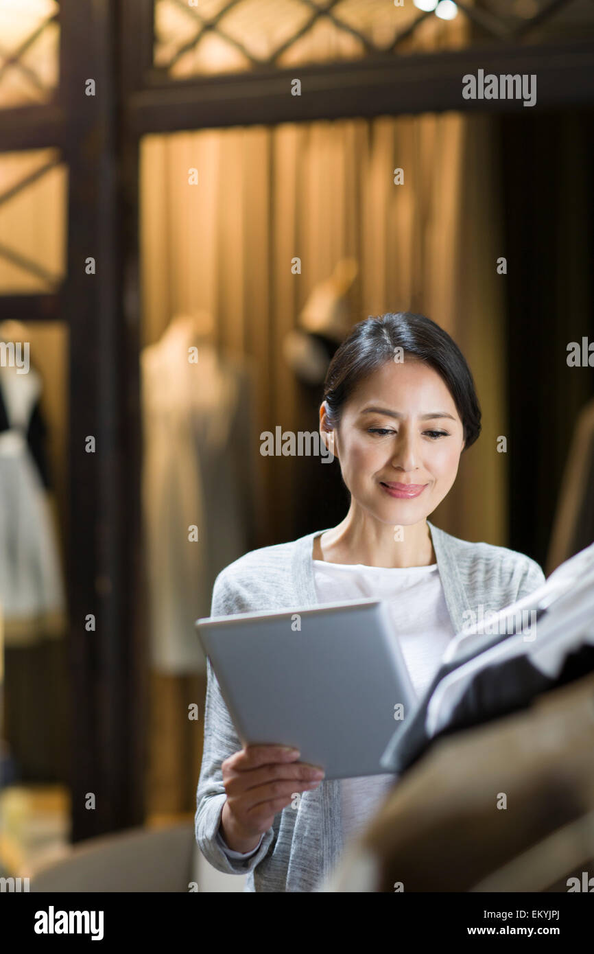 Clothing store owner with digital tablet Stock Photo Alamy