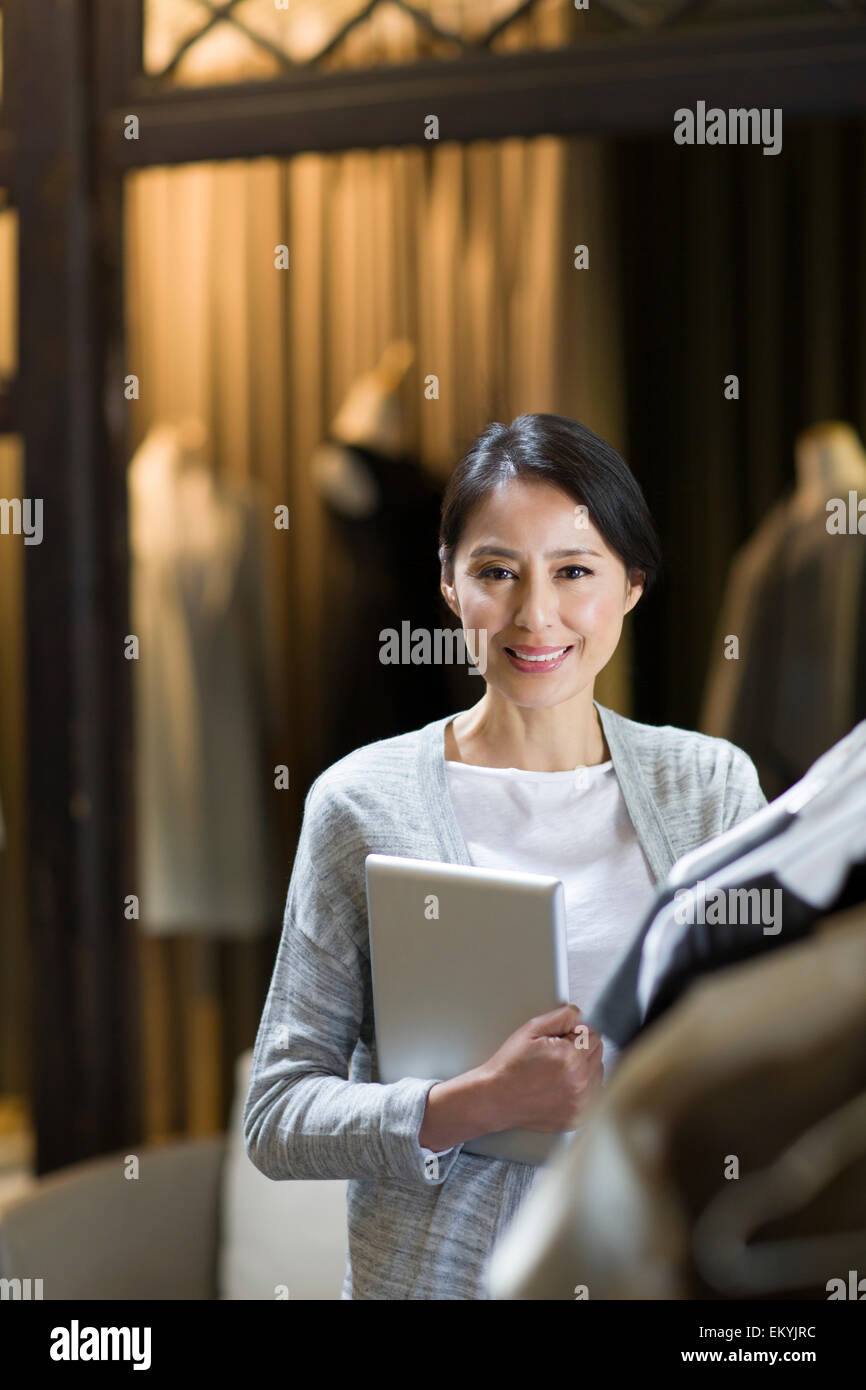 Clothing store owner with digital tablet Stock Photo Alamy