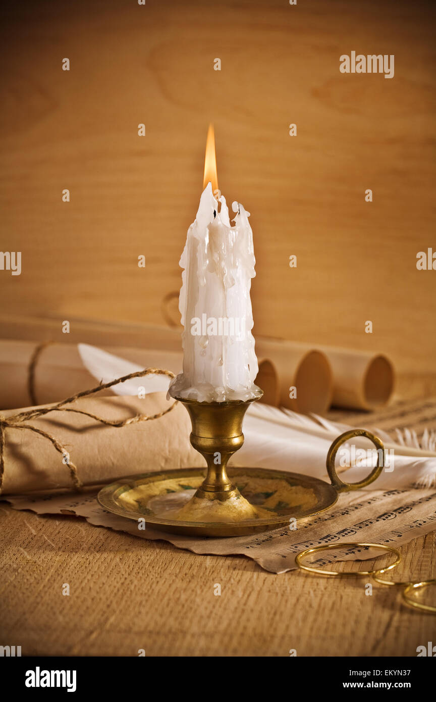 view on the burning candle with old notes sheet Stock Photo Alamy