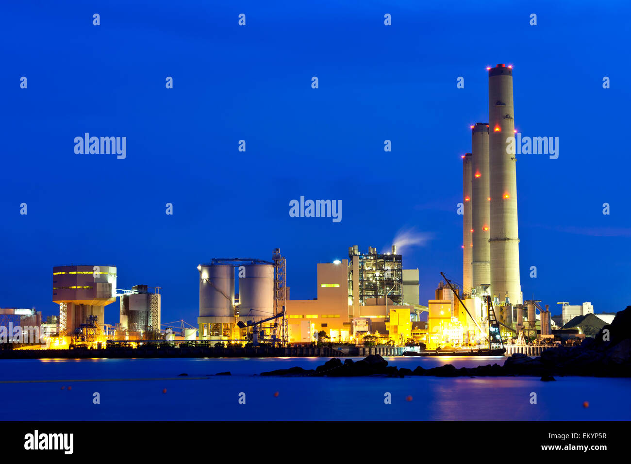 Smoking industrial power plant at night Stock Photo - Alamy