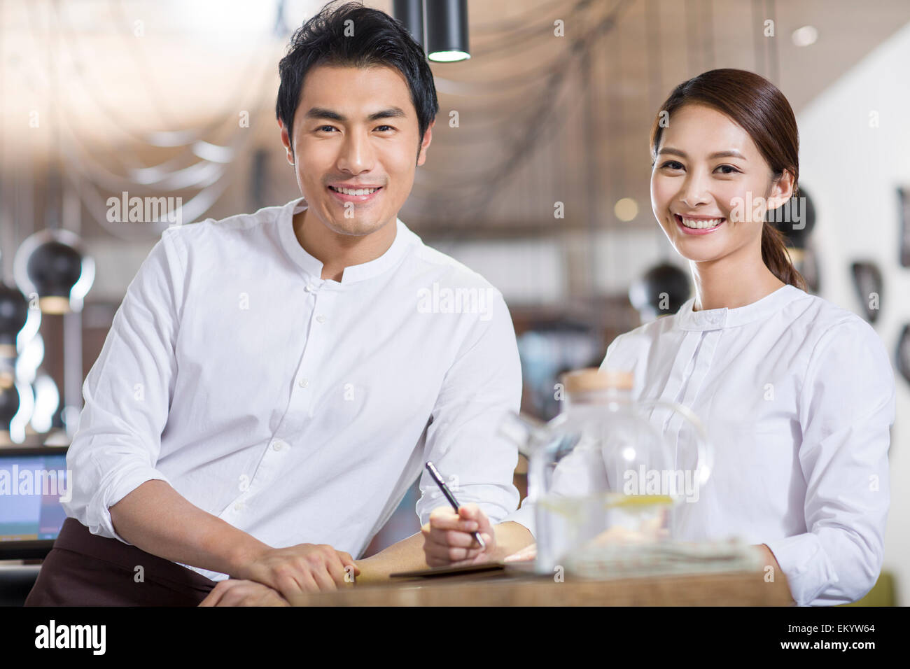 Wait staff standing in restaurant Stock Photo Alamy