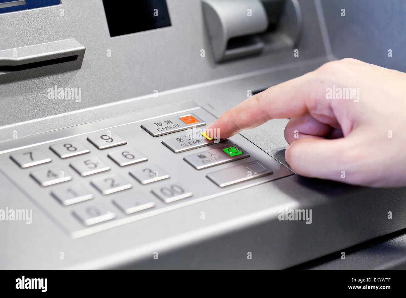 Human hand using ATM machine Stock Photo