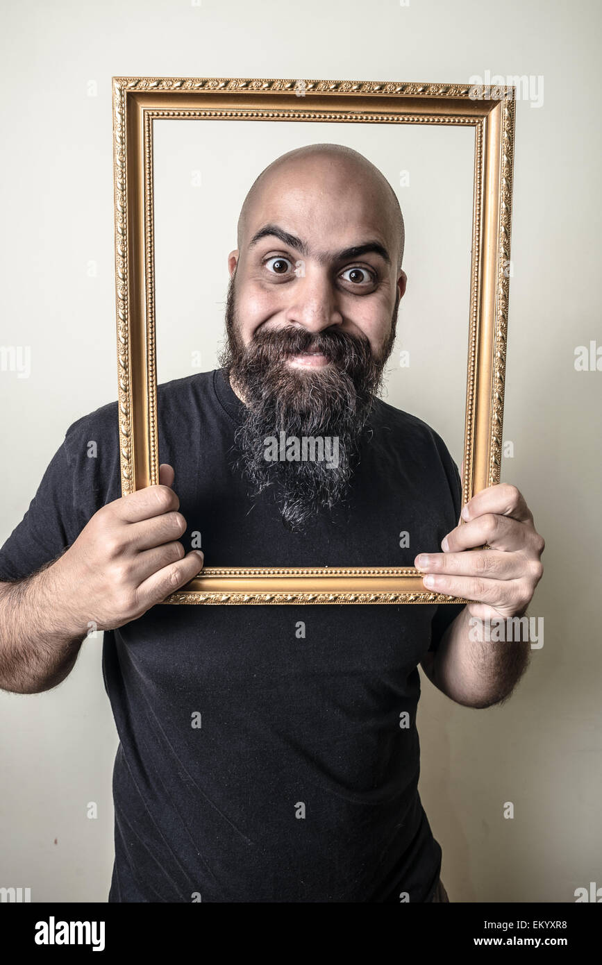 funny bearded man with golden frame Stock Photo
