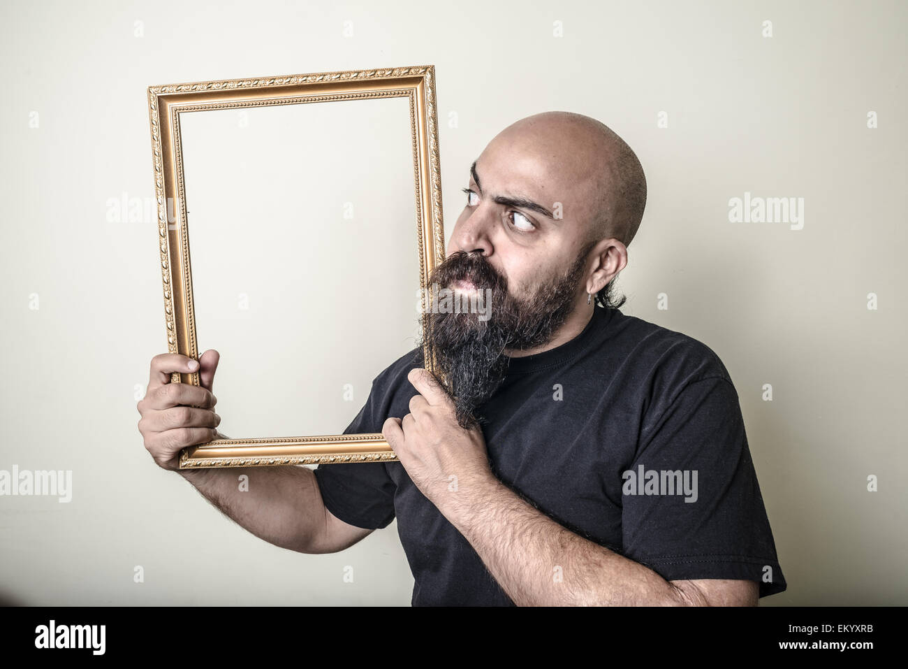 funny bearded man with golden frame Stock Photo