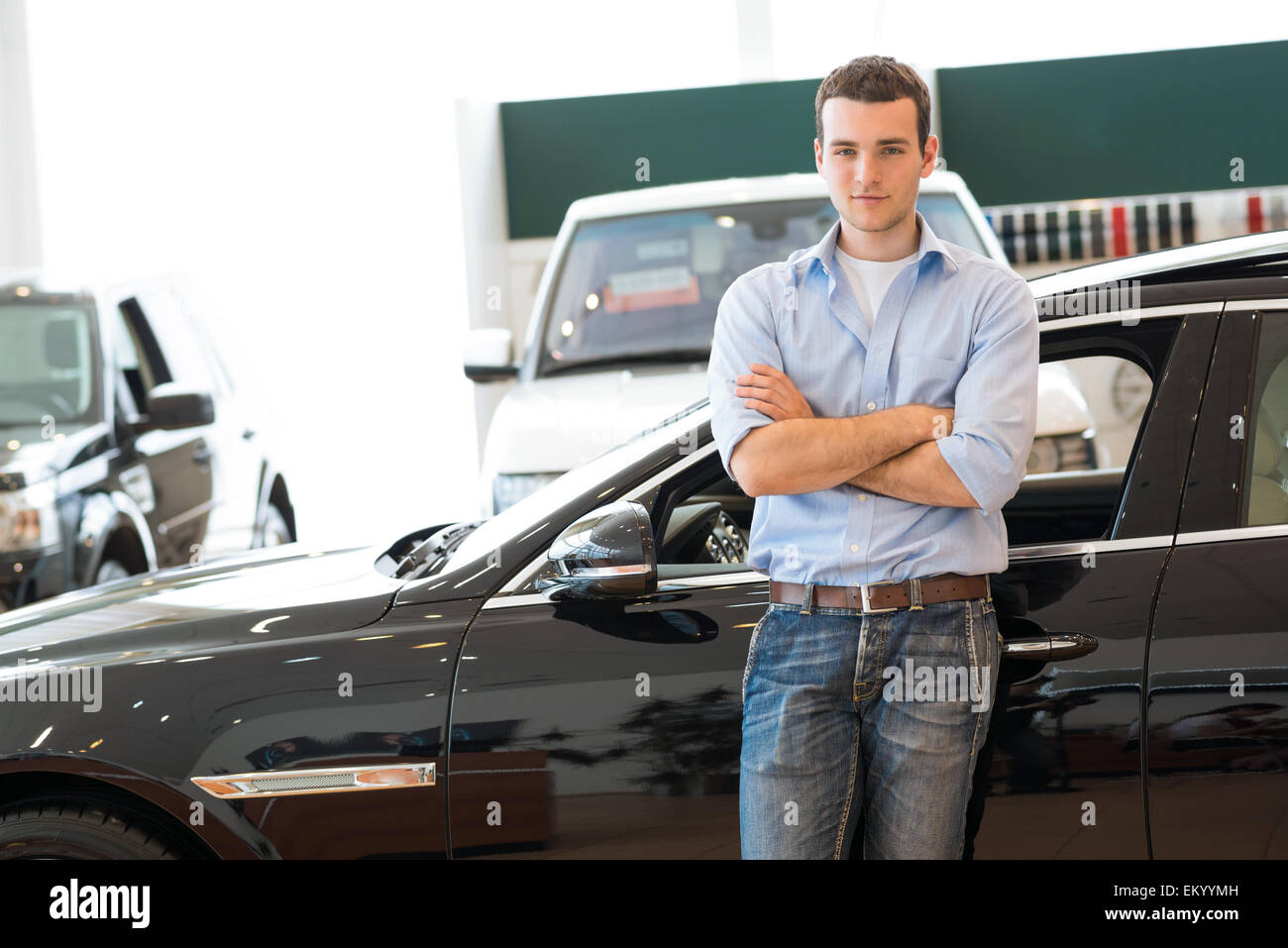 man standing near a car Stock Photo Alamy