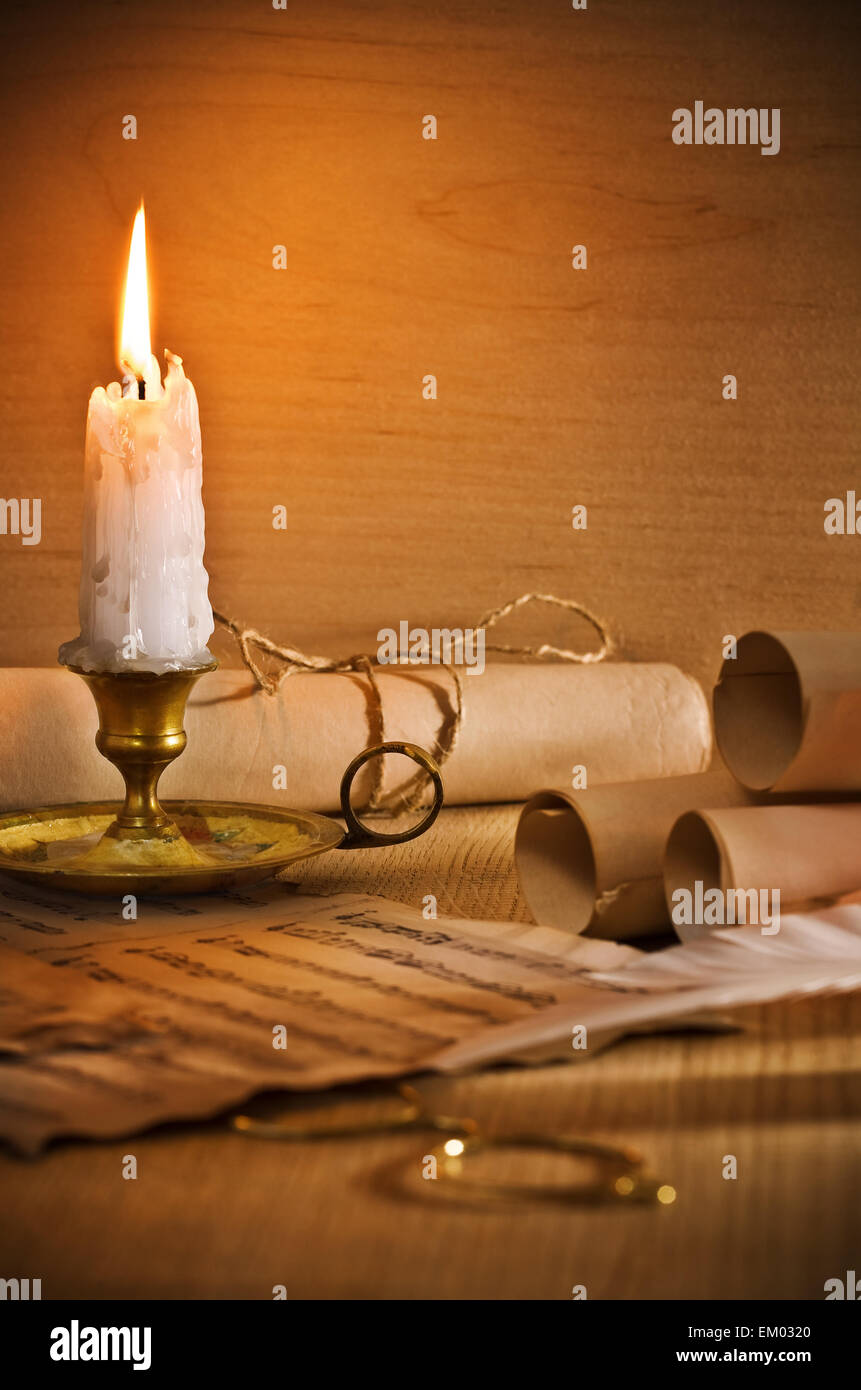 flaming candle and antic musical notes Stock Photo