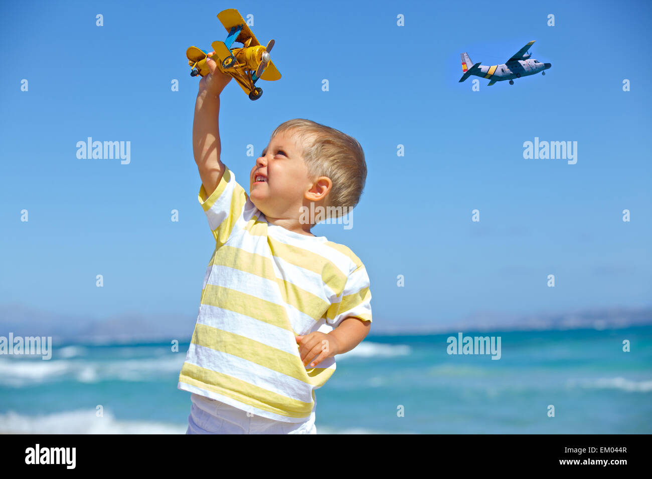 Boy playing with a toy airplane Stock Photo - Alamy