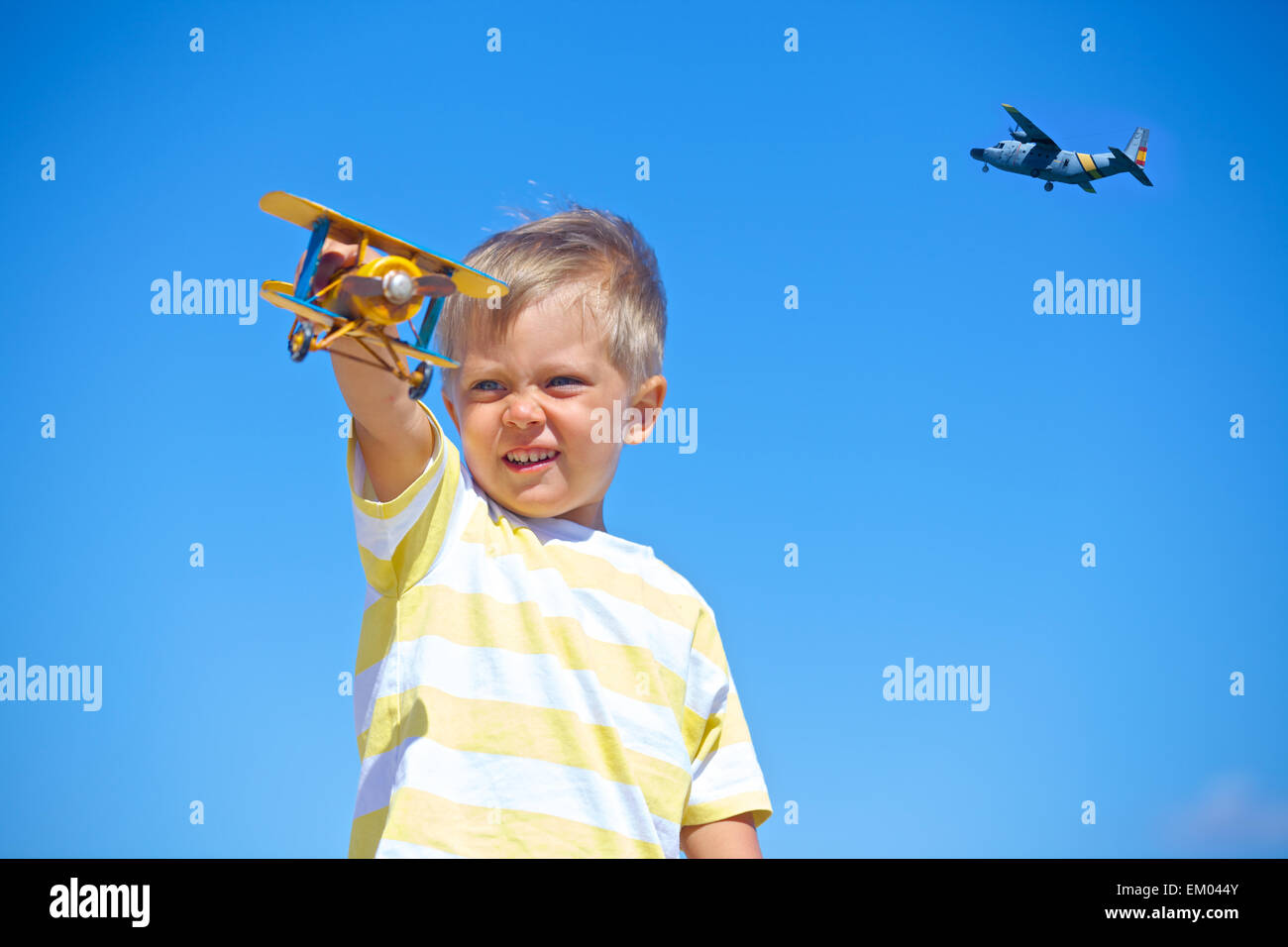 Boy playing with a toy airplane Stock Photo - Alamy
