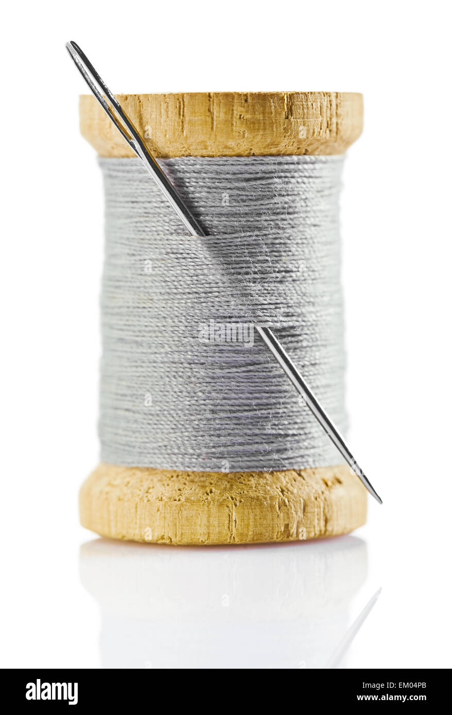spool with gray thread and nidle Stock Photo