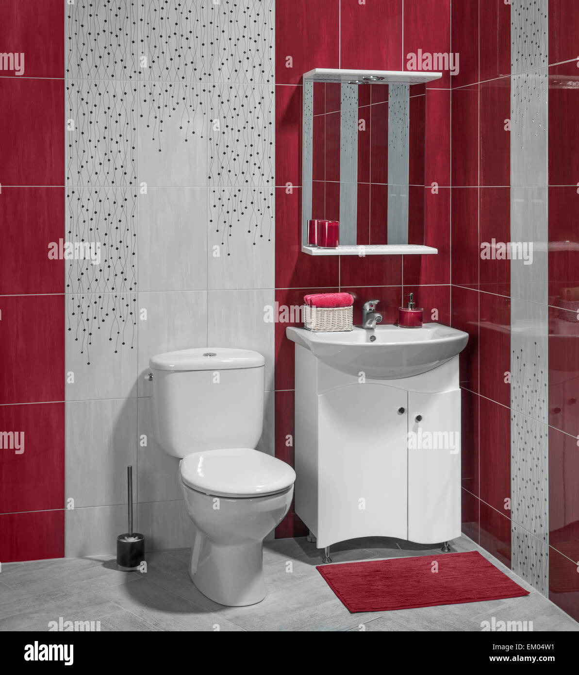 Beautiful interior of bathroom with sink and toilet; decorated with red tiles Stock Photo