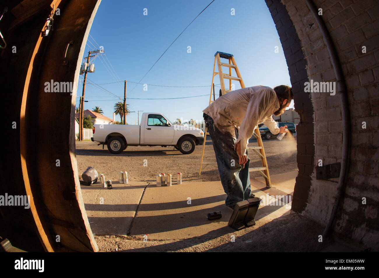 Male Graffiti Artist with Spray Cans Stock Photo - Alamy