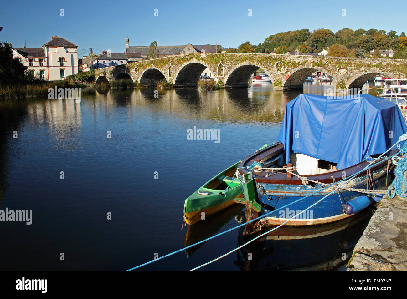 Covered Boat And Stone Bridge Over River Barrow; Graiguenamanagh, County Kilkenny, Ireland Stock Photo