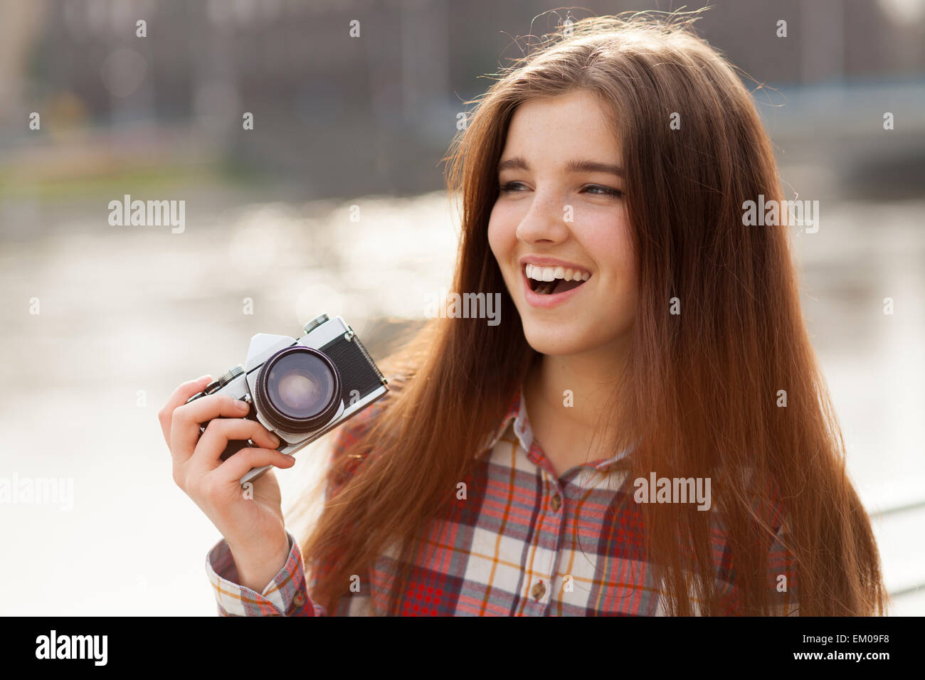 Portrait of a young woman with photo camera Stock Photo - Alamy