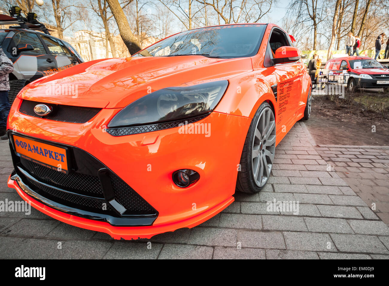 Saint-Petersburg, Russia - April 11, 2015: Bright orange sporty styled Ford focus car stands parked on the street. Wide angle cl Stock Photo