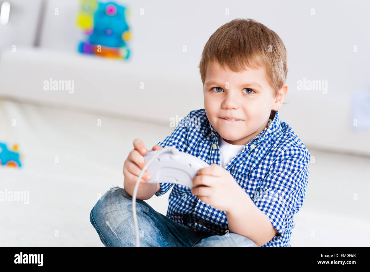 Boy playing on a game console Stock Photo