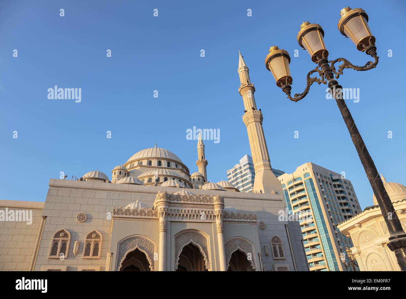 SHARJAH, UAE - NOVEMBER 6, 2013: Mosque at sunrise in Sharjah. It is the most industrialized emirate in UAE. Stock Photo