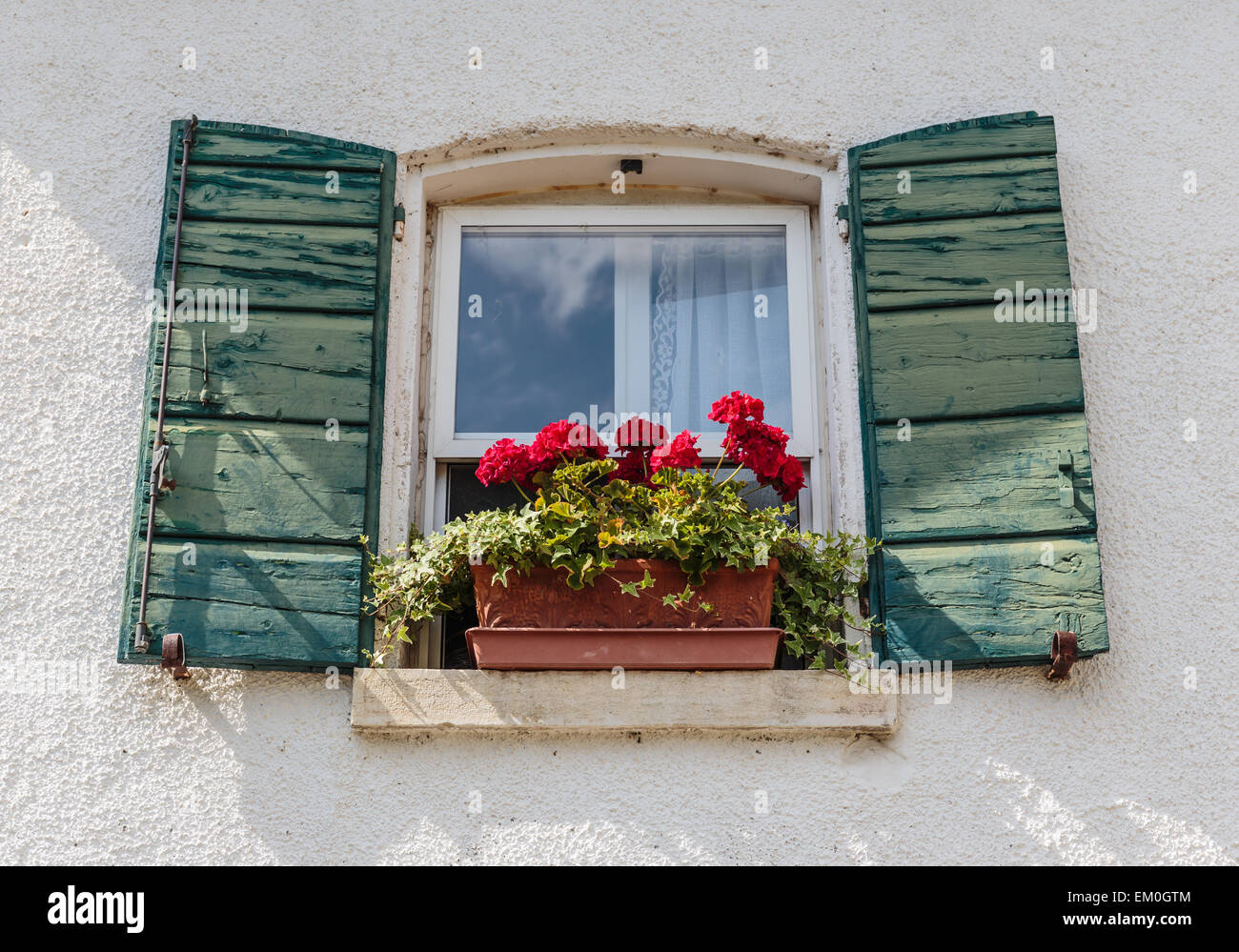 Window in an old house decorated with flower pots and flowers Stock ...