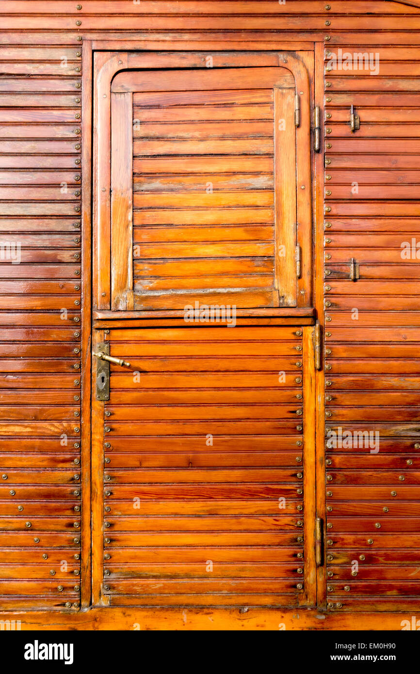 door of an old circus caravan, laquered wood panels Stock Photo