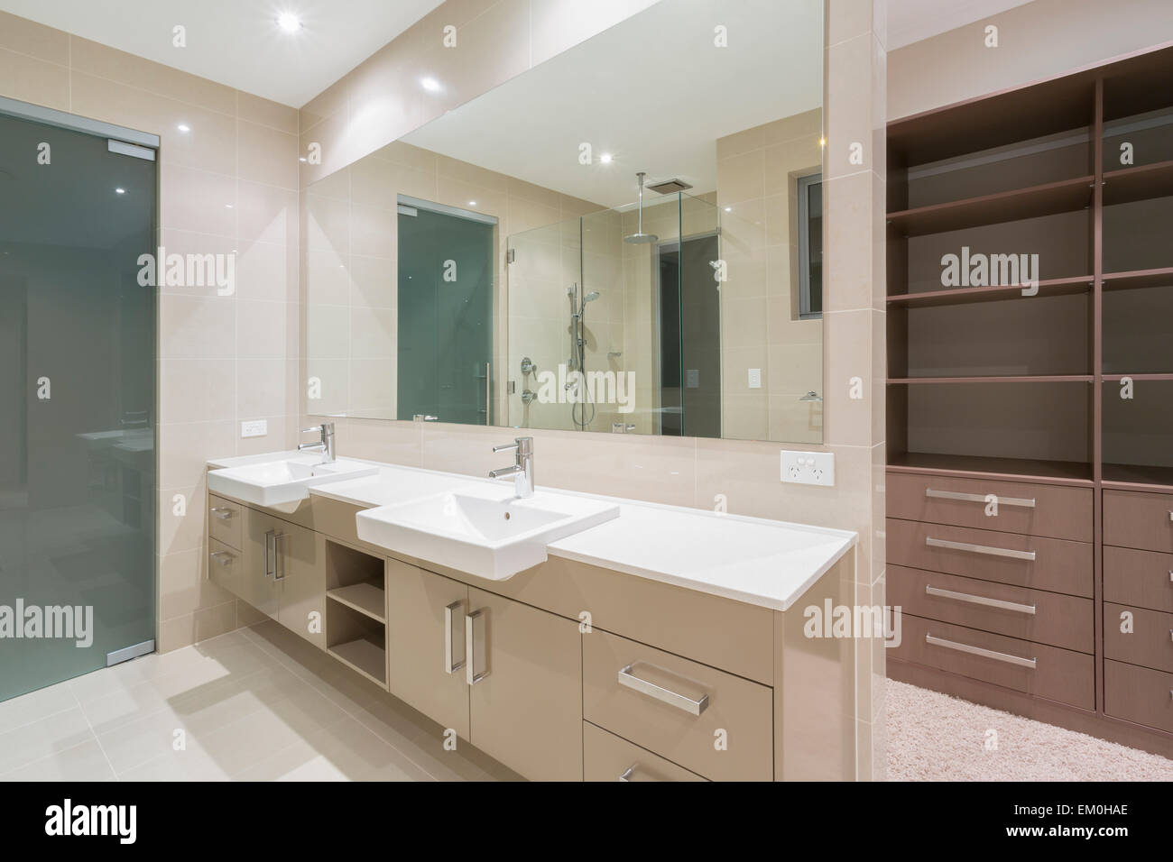 Spacious contemporary bathroom with walk in wardrobe Stock Photo - Alamy