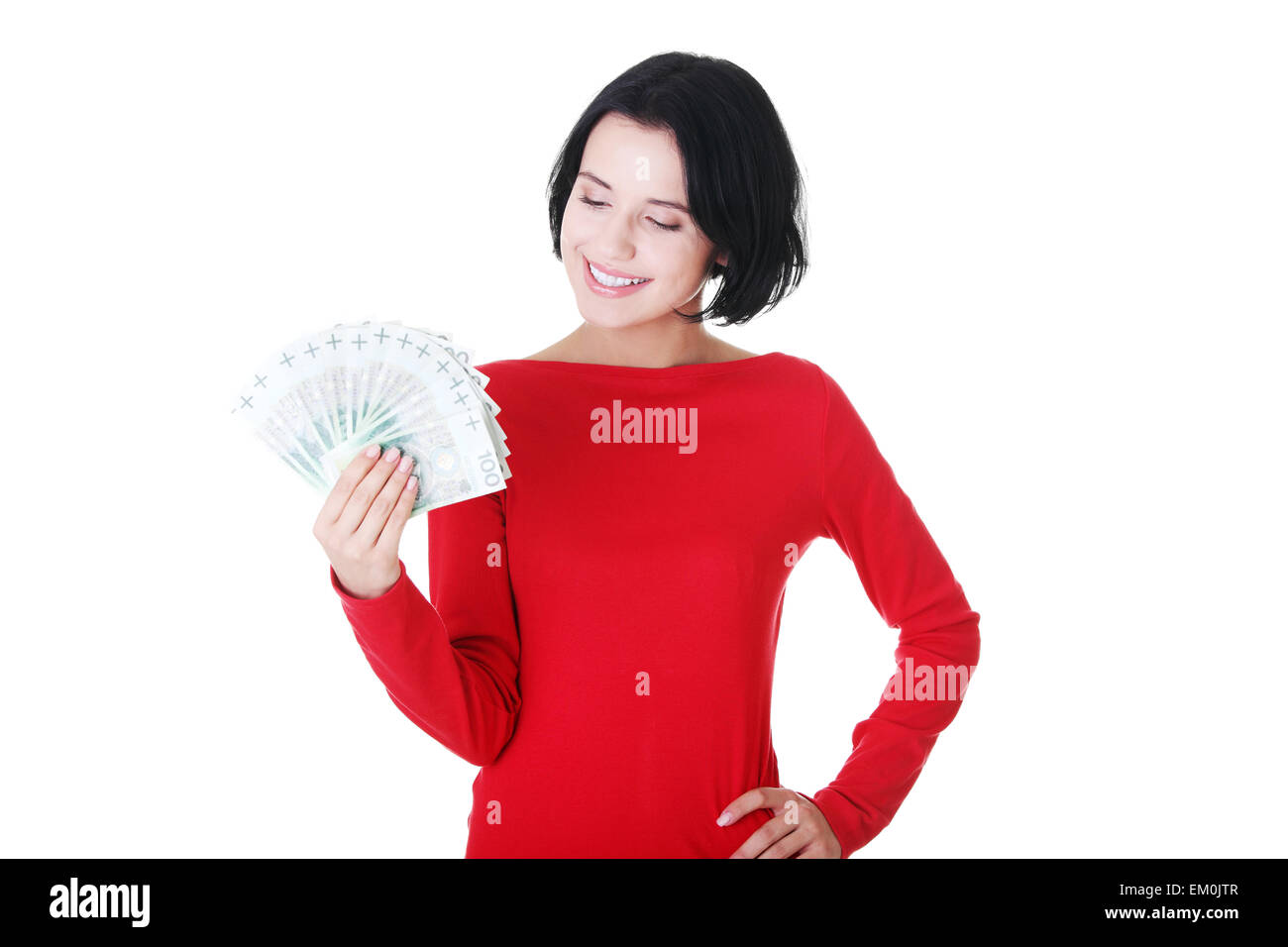 Cheerful young lady holding cash Stock Photo - Alamy