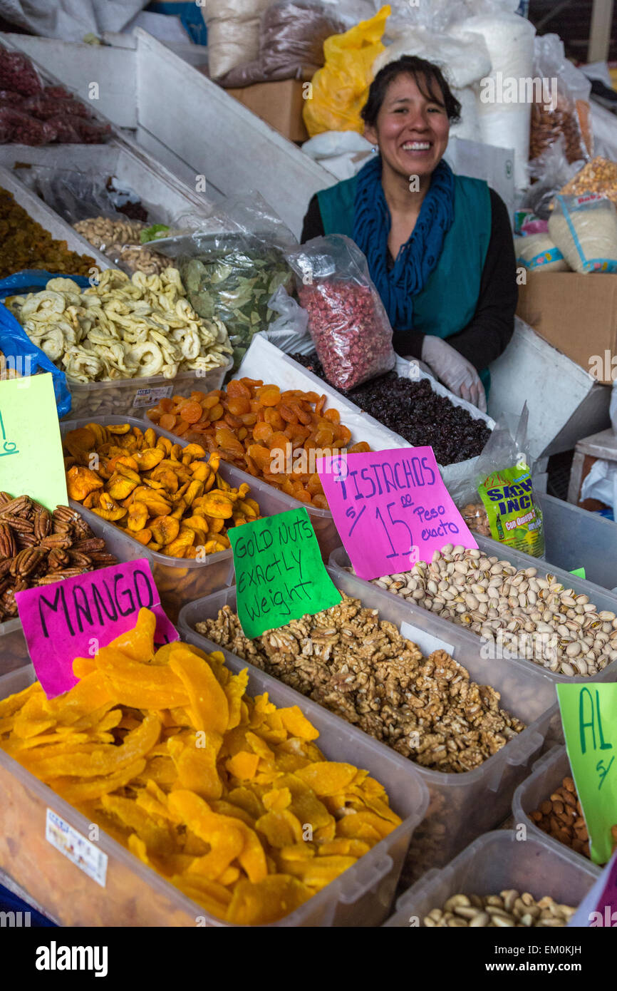 Peru, Cusco, San Pedro Market.  Woman Selling Dried Fruits and Nuts. Stock Photo
