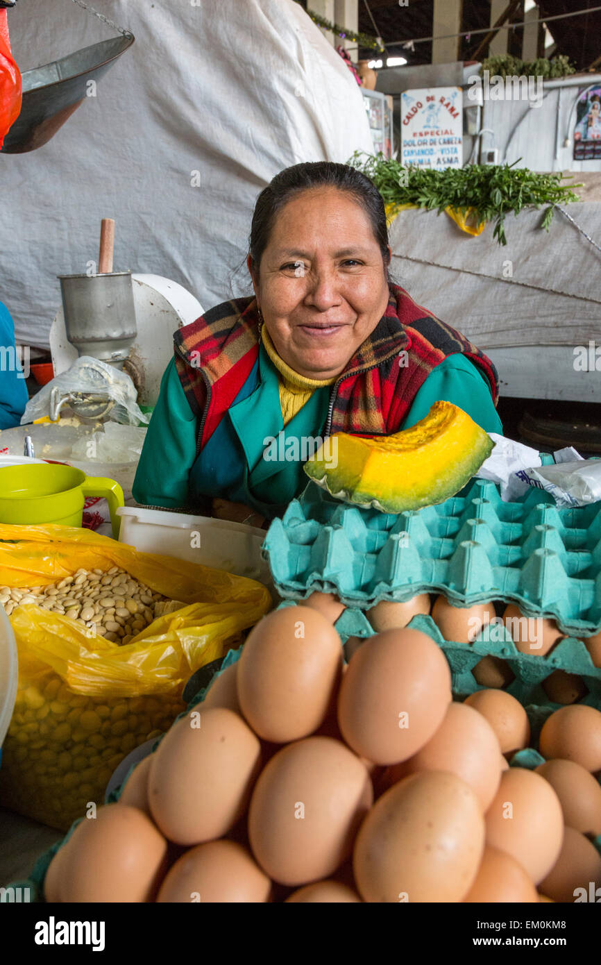 Peru, Cusco, San Pedro Market.  Woman Selling Eggs, Beans, and Melon. Stock Photo