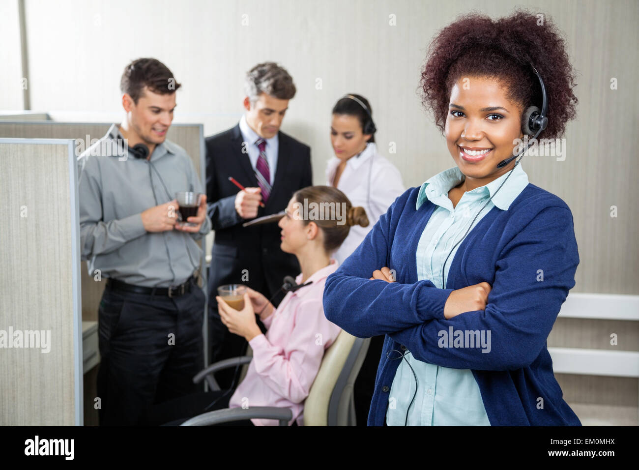 Female Customer Service Representative Standing Arms Crossed Stock