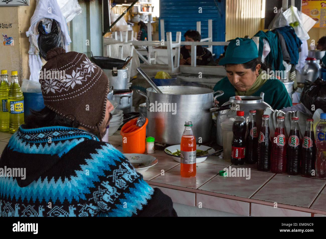 Peru, Cusco, San Pedro Market.  Customer Eating in the Food Court Area of the Market. Stock Photo