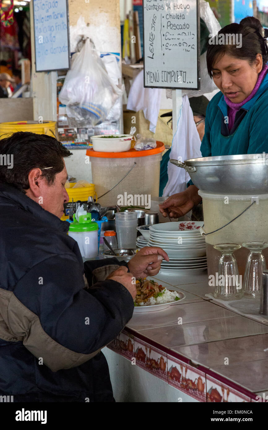 Peru, Cusco, San Pedro Market.  Customer Eating in the Food Court Area of the Market. Stock Photo