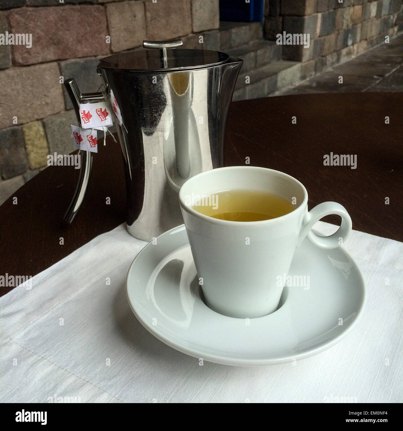 Peru.  Coca Tea, Said to Lessen the Symptoms of Altitude Sickness at Cusco's 11,000-foot Altitude.  Inca Stonework in Background Stock Photo