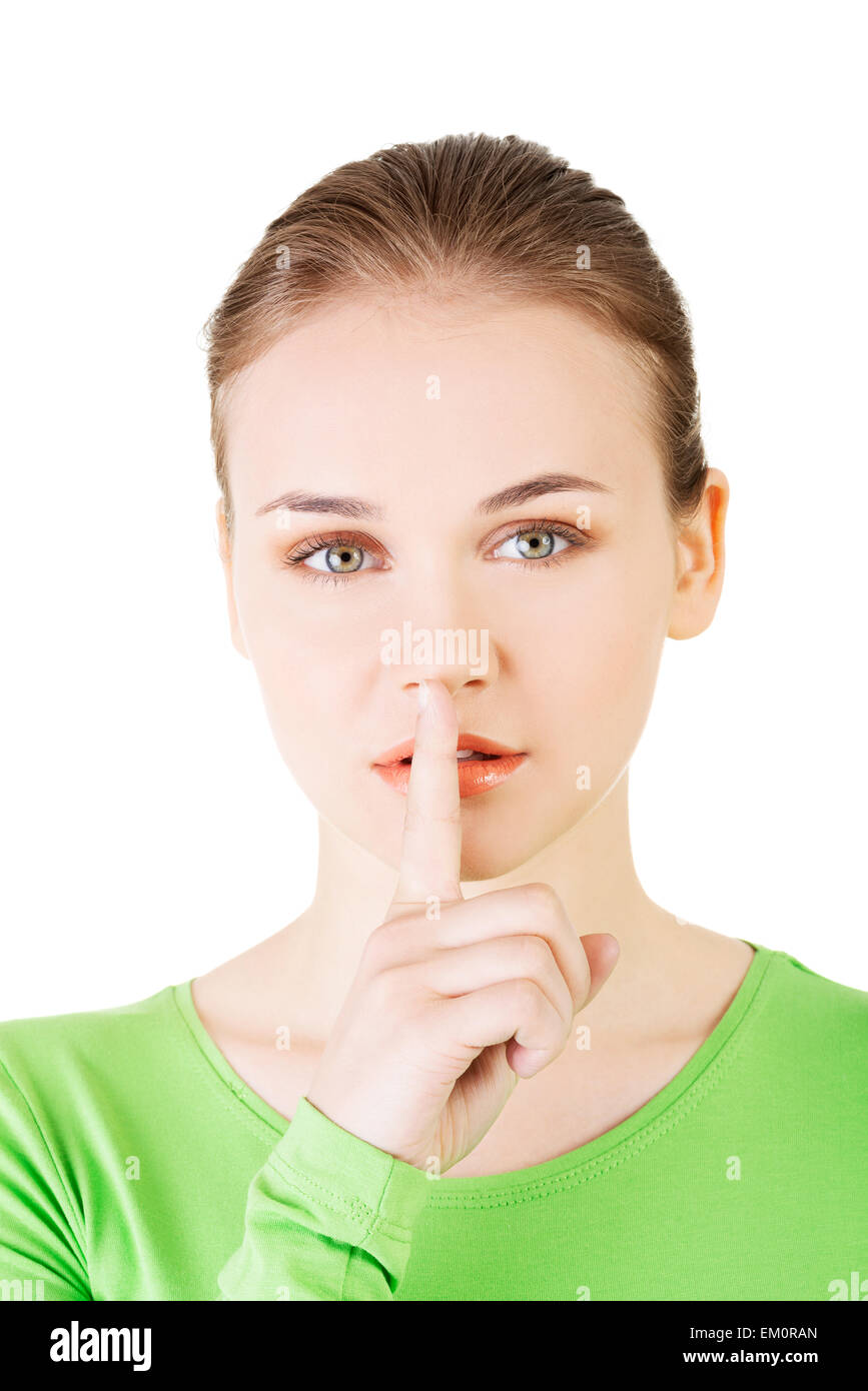 Teen girl with finger on her lips Stock Photo - Alamy