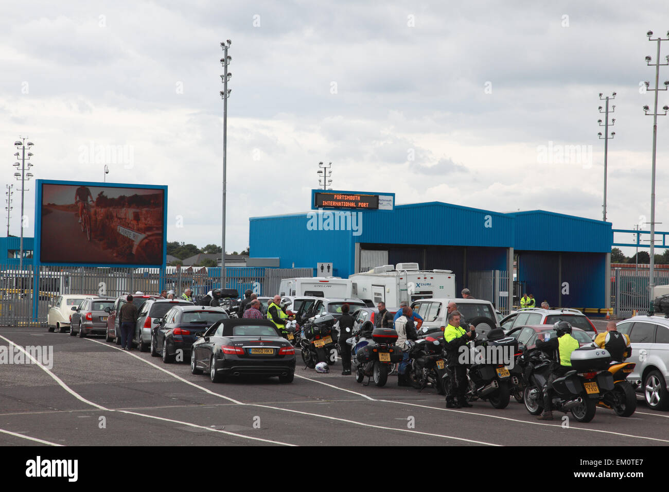 Cars, motorbikes and passengers waiting to board the Brittany ferry Pont Aven at the port terminal in Portsmouth, England Stock Photo