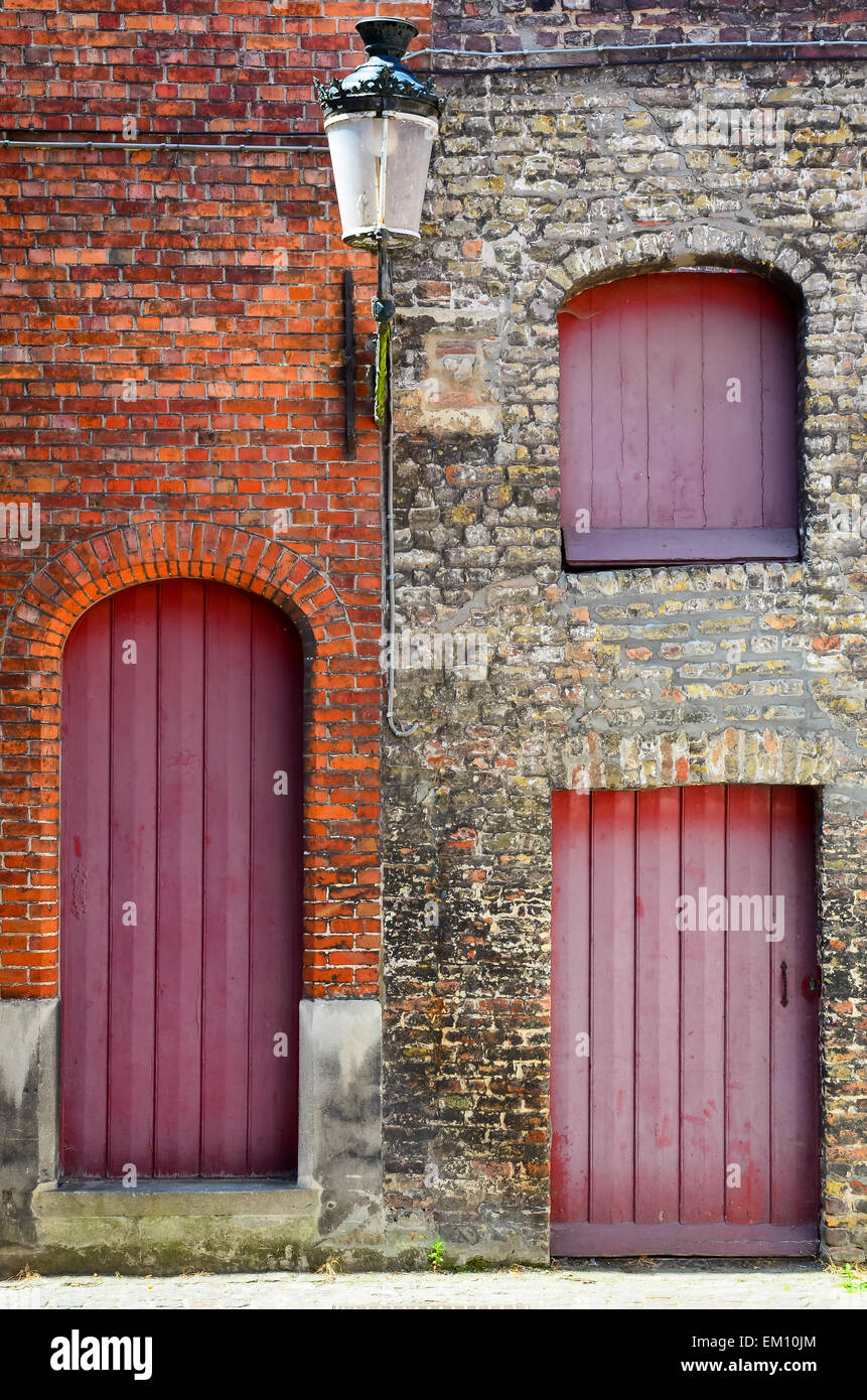 Old vintage brick wall with red wooden doors and windows Stock Photo ...