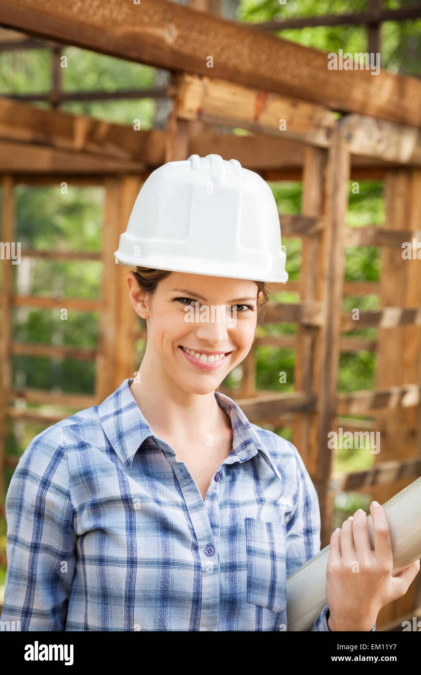 Beautiful Architect Holding Blueprint At Construction Site Stock Photo ...