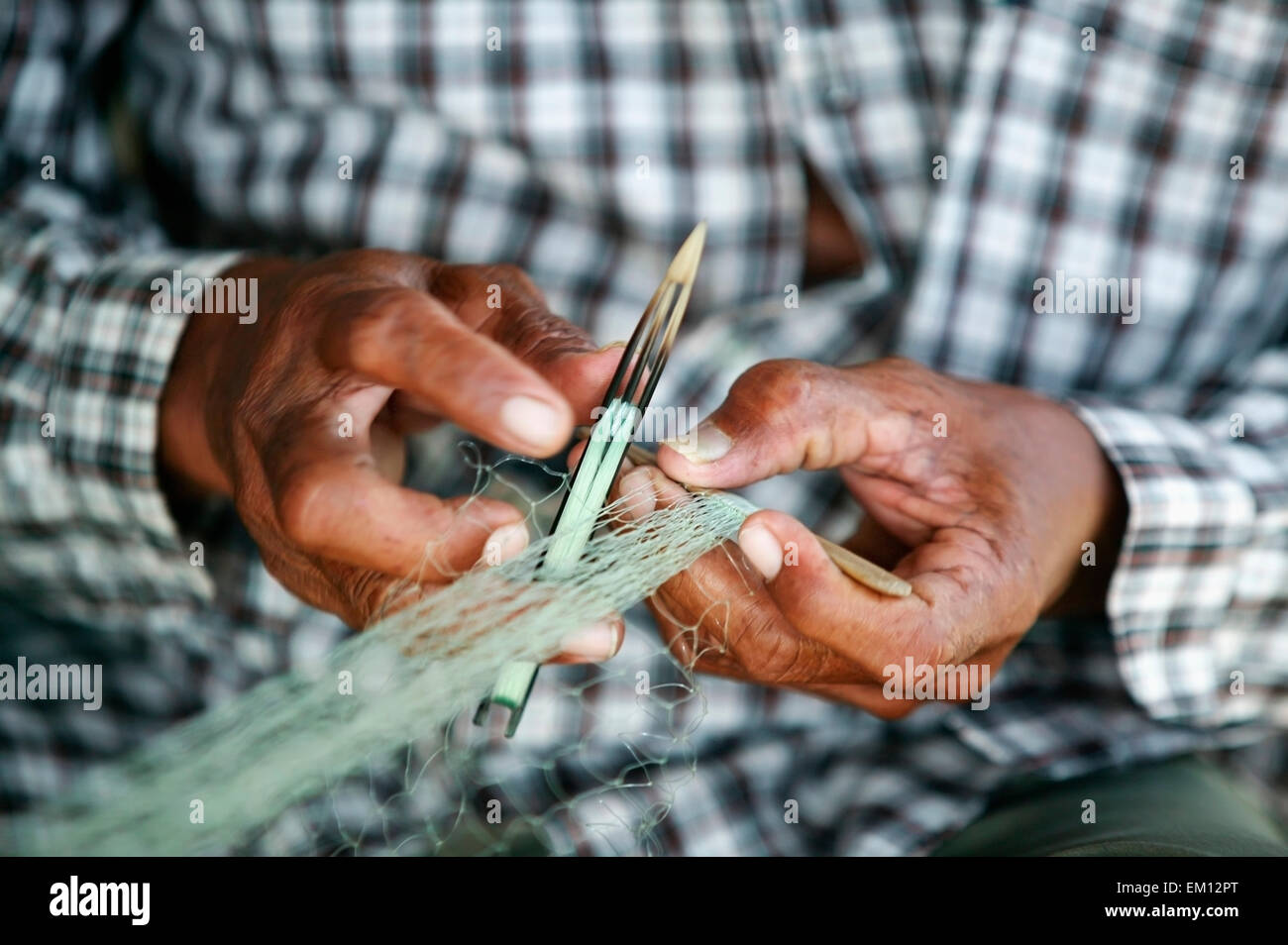 Fisherman repairing nets, near Banda Aceh; Aceh Province, Sumatra, Indonesia Stock Photo