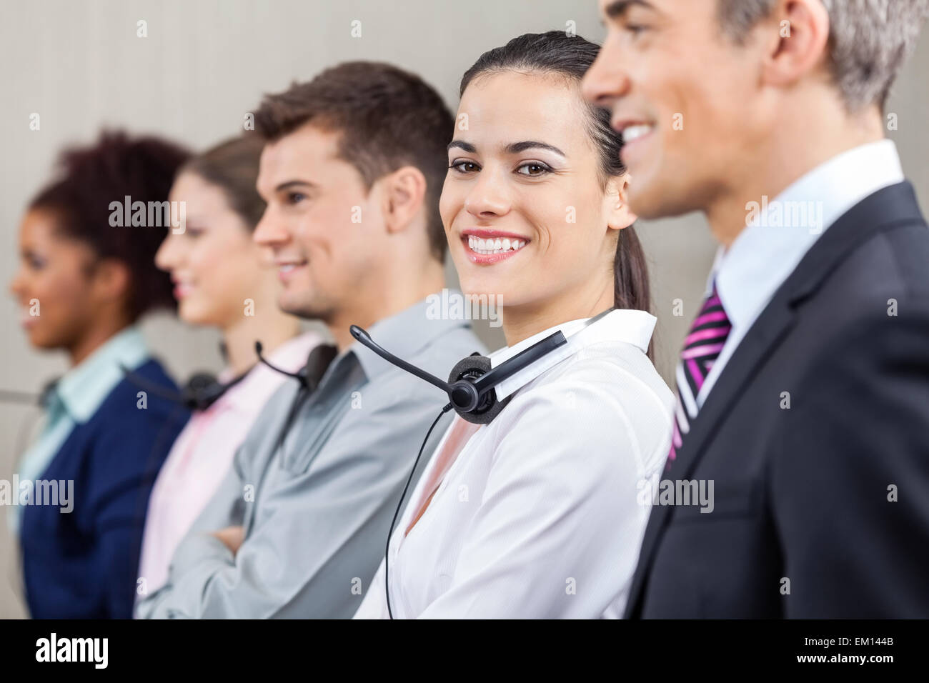 Customer Service Representative Standing With Colleagues And Man Stock