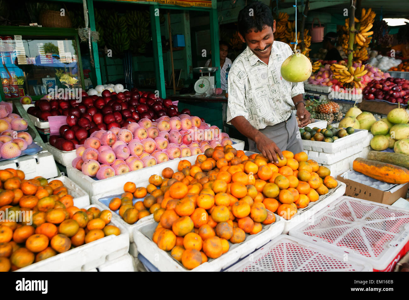 Stall holder sells fruit from the market; Banda Aceh, Sumatra, Indonesia Stock Photo