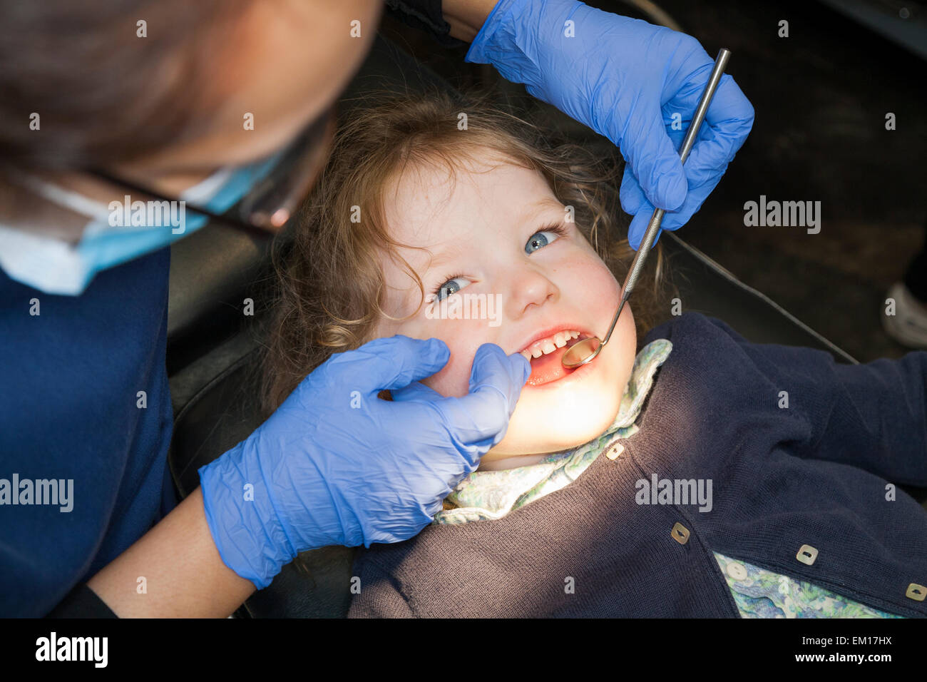 Toddler girl / 2 or 3  yr / two or three year old child during check up with childrens dentist / children's dental practice. UK Stock Photo