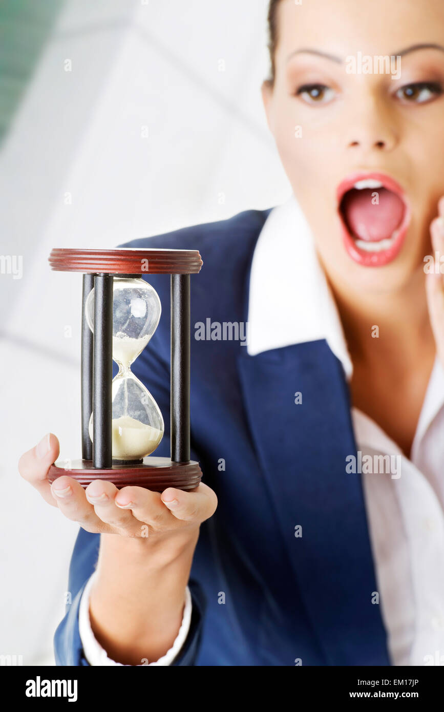 Young business woman with hourglass - time concept Stock Photo - Alamy