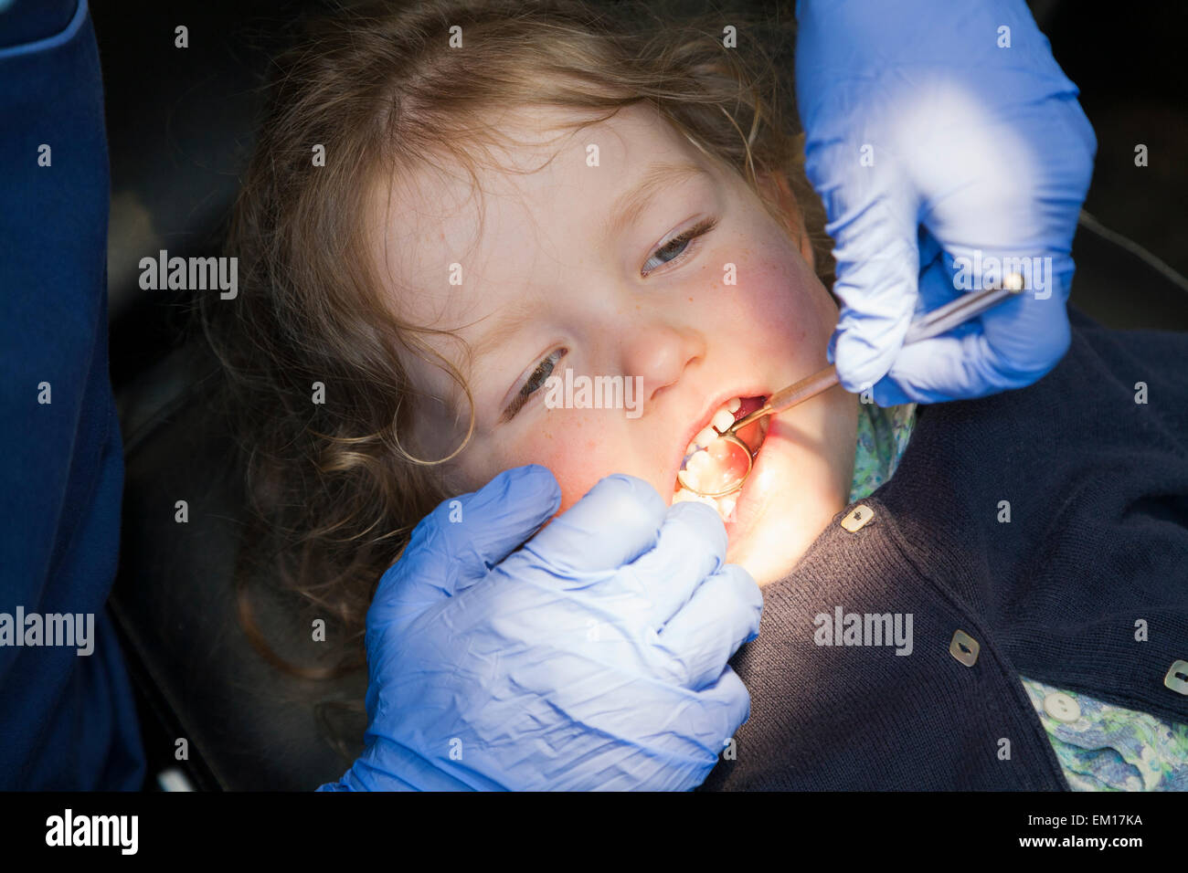 Toddler girl / 2 or 3  yr / two or three year old child during check up with childrens dentist / children's dental practice. UK Stock Photo