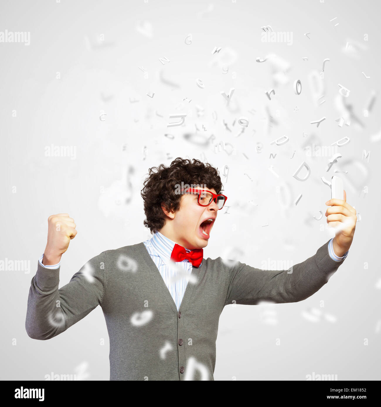 Young man shouting at his mobile phone Stock Photo