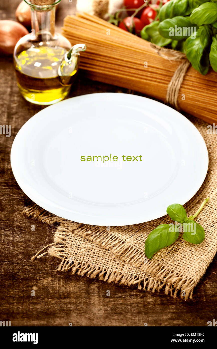 whole wheat spaghetti, ingredients and plate for text Stock Photo